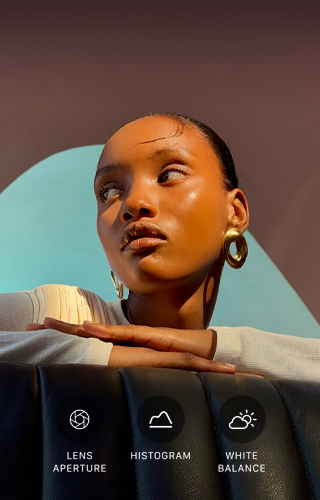Close up portrait of a well-lit model with a colourful background, demonstrating the pro camera system's Pro controls UI: Lens Aperture, Histogram, White Balance